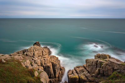 Scenic view of sea against cloudy sky