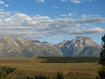 Scenic view of mountains against cloudy sky