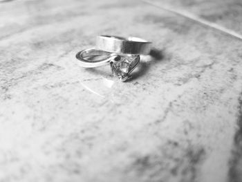 Close-up of wedding rings on table