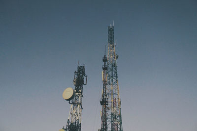 Low angle view of communications tower against sky