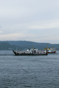 Boat sailing in sea against sky