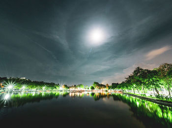 Scenic view of lake against sky at night