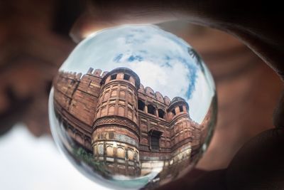 Close-up of reflection of building on mirror