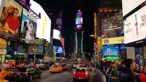 Cars on city street at night