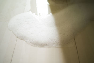 Close-up of white curtain hanging on wall at home