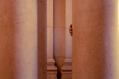 Close-up of hand against wall