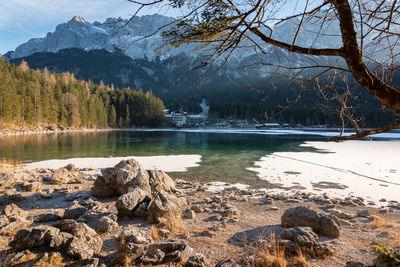 Scenic view of lake by trees and mountains