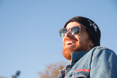 Portrait of man wearing sunglasses against clear sky