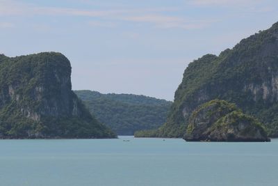 Scenic view of sea and mountains against sky