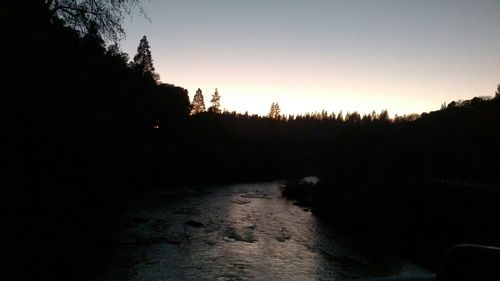 Silhouette of trees against sky at sunset