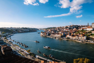 High angle view of buildings by sea against sky