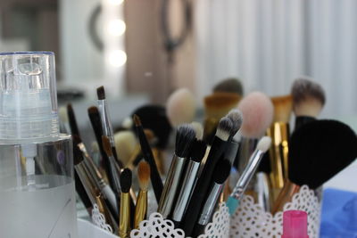 Close-up of make-up brushes in container