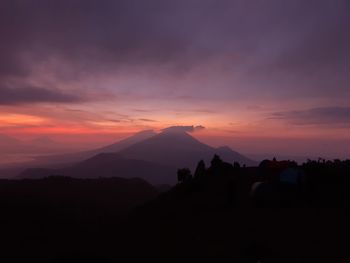 Scenic view of silhouette mountains against sky during sunset