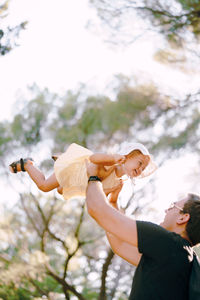 Low angle view of couple holding hands