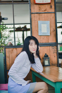 Portrait of woman sitting on table