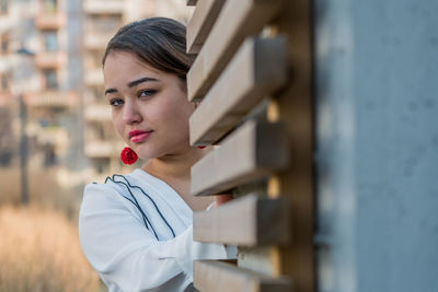 Portrait of young woman posing outdoors