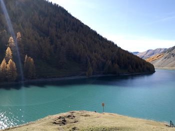 Scenic view of lake and mountains against sky