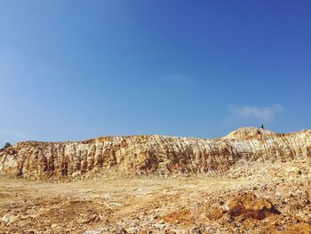 Low angle view of mountain against clear blue sky