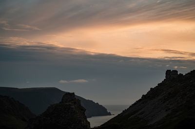 Scenic view of mountains against sky at sunset