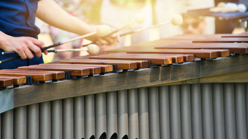 Musician playing on a marimba, an instrument from the group of xylophones