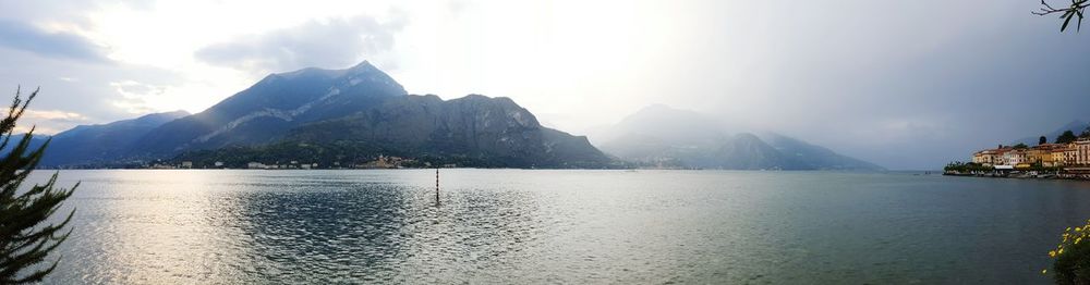 Scenic view of lake against cloudy sky