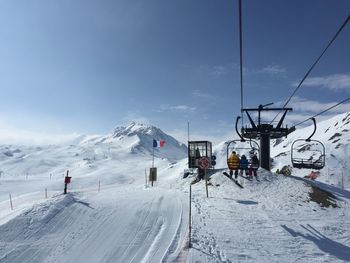 People skiing on snow covered landscape