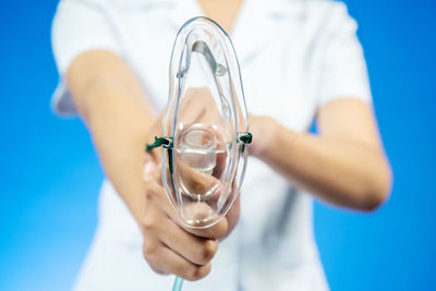 Close-up of man holding glass