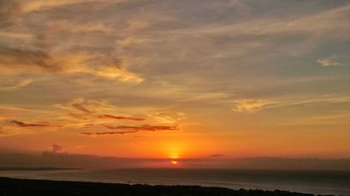 Scenic view of sea against romantic sky at sunset