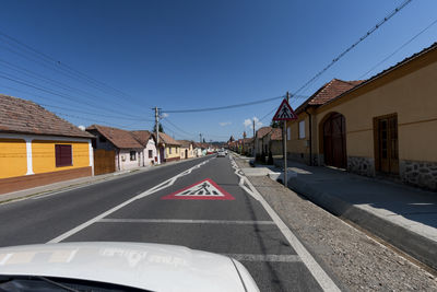 Road amidst buildings against sky in city