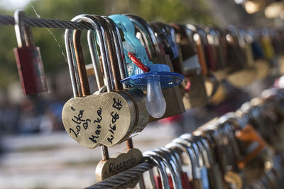 Close-up of padlocks hanging on metal