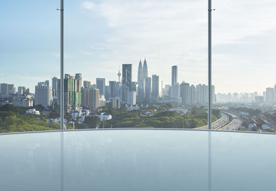 Modern buildings in city against cloudy sky