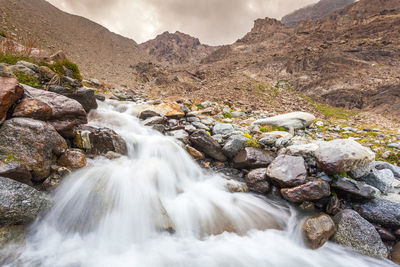 Scenic view of stream flowing through rocks