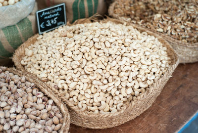 High angle view of cashew nuts in basket at market for sale