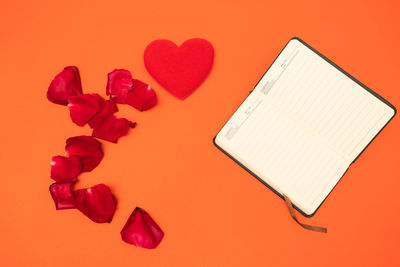 High angle view of heart shape on red paper