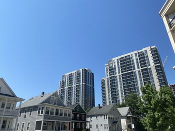 Low angle view of buildings against clear blue sky