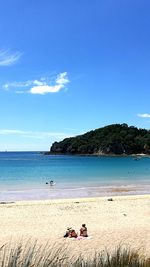 Scenic view of beach against clear blue sky