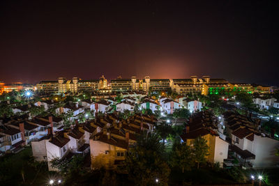 High angle view of buildings lit up at night