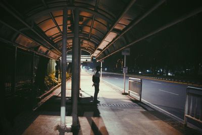 Man at railroad station at night