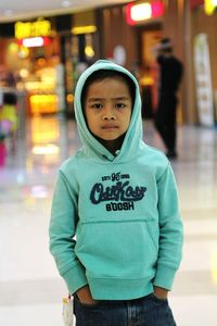 Portrait of boy standing at shopping mall