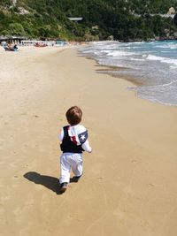 Full length of boy playing on beach