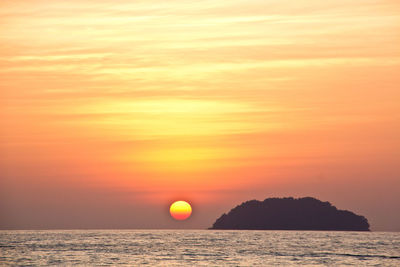 Scenic view of sea against orange sky