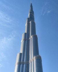 Low angle view of modern building against blue sky