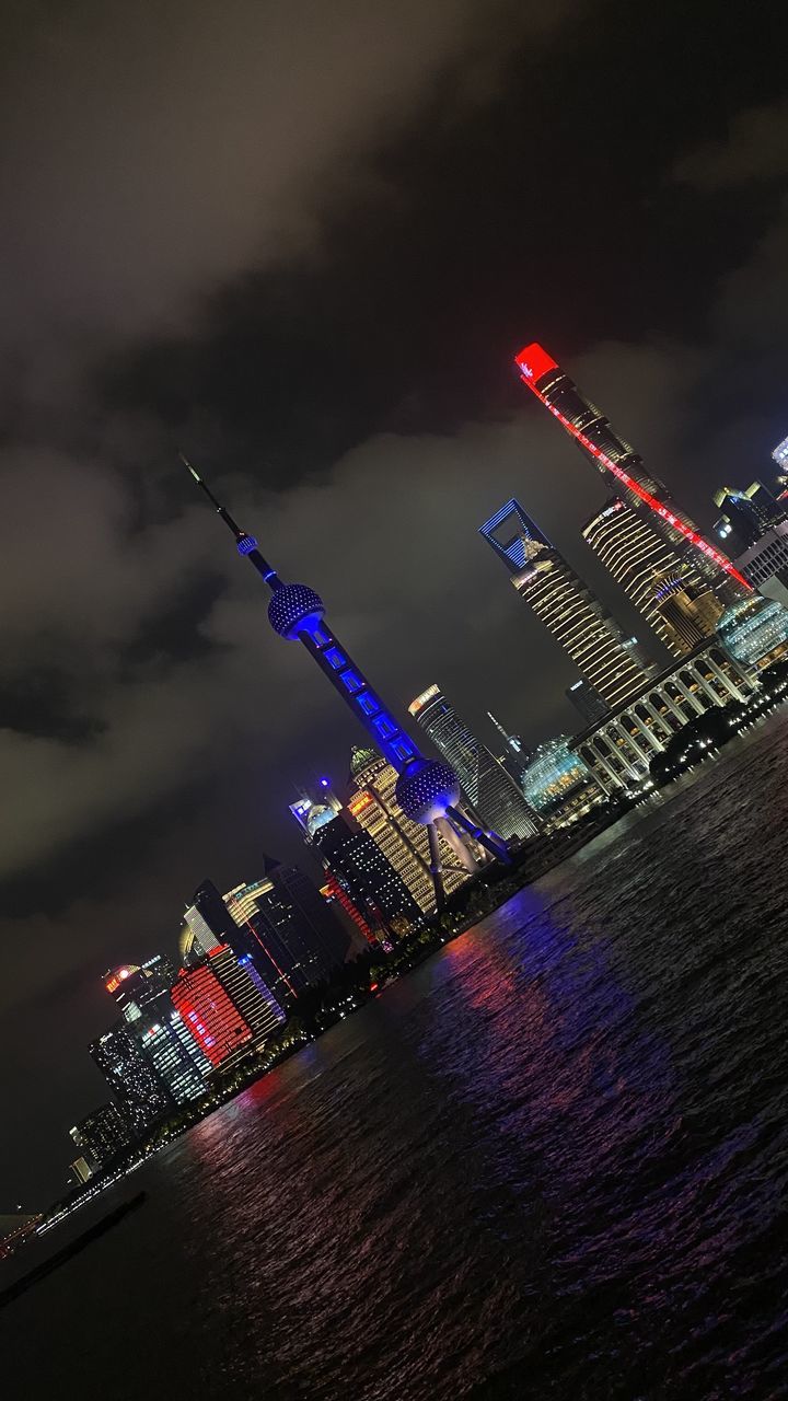 ILLUMINATED BUILDING IN CITY AT NIGHT