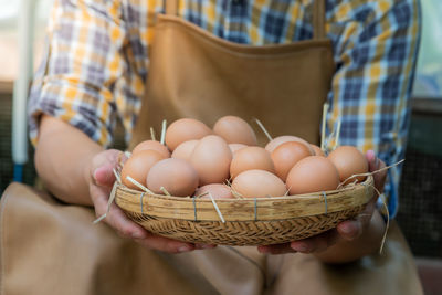 Midsection of man holding basket