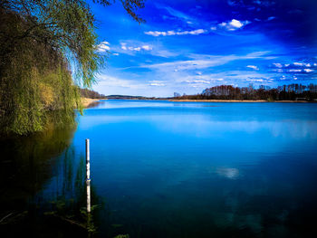 Scenic view of lake against blue sky