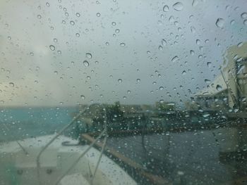 Full frame shot of wet glass window in rainy season