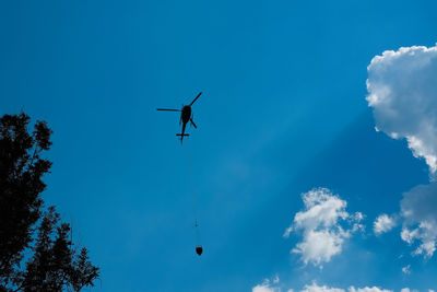 Low angle view of airplane flying against sky