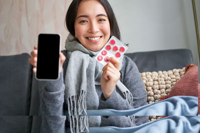 Portrait of young woman using mobile phone