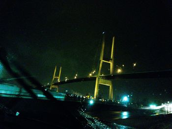 Low angle view of illuminated city against sky at night