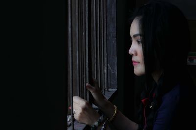 Portrait of young woman looking away at home